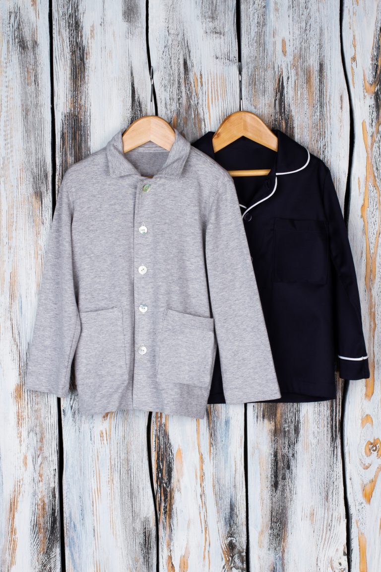 Boys shirts on wooden background