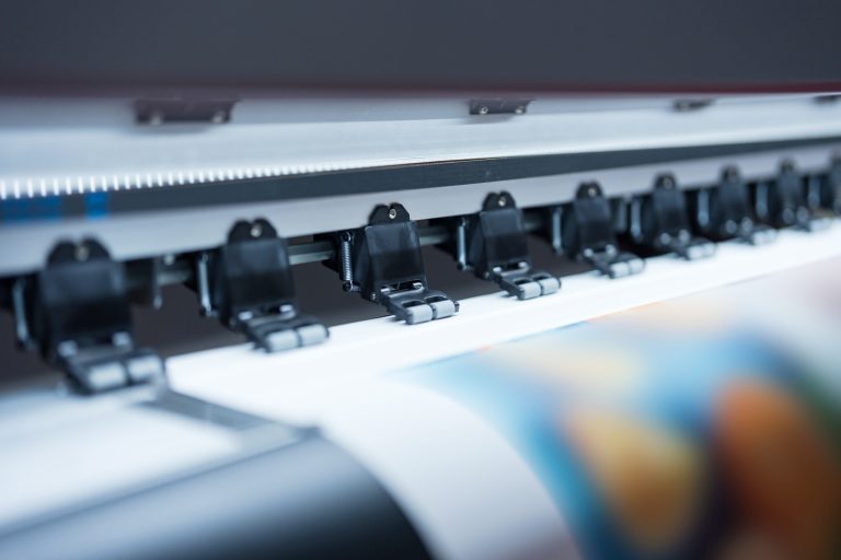 Close-up of large format printer heads in action